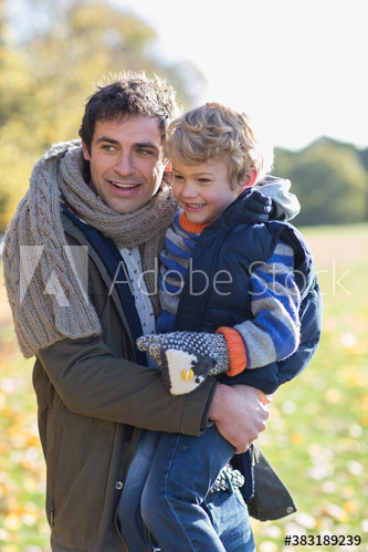Happy father and son in autumn park
