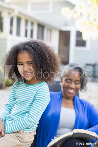 Happy granddaughter on patio with grandmother