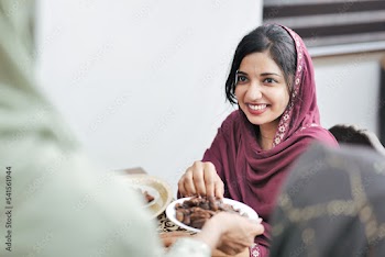 Happy Indian Muslim family celebrating Eid Mubarak and Having Eid Feast at Home