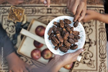 Happy Indian Muslim family celebrating Eid Mubarak and Having Eid Feast at Home