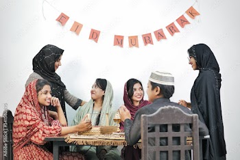 Happy Indian Muslim family celebrating Eid Mubarak and Having Eid Feast at Home
