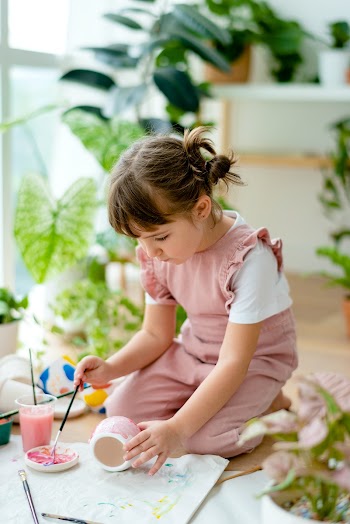 Happy kid at home DIY pot painting hobby | Free stock photo | High Resolution image