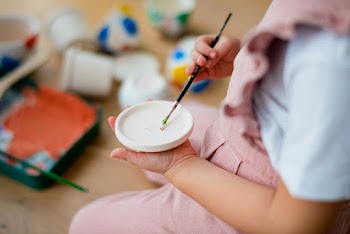 Happy kid at home DIY pot painting hobby | Free stock photo | High Resolution image