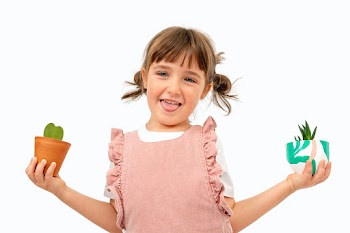 Happy kid with plants studio shot | Free stock photo | High Resolution image