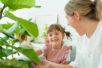 Happy little girl and mom at home with indoor… | Free stock photo | High Resolution image