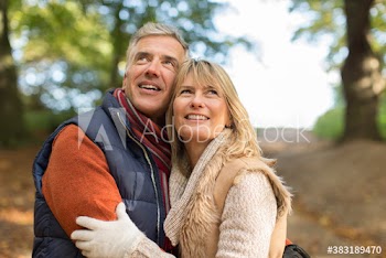 Happy mature couple in autumn park