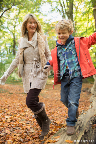 Happy mother and son in autumn woods