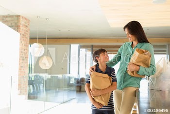 Happy mother and son with grocery bags