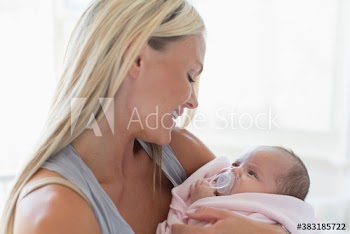Happy mother holding baby daughter
