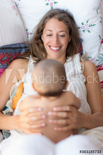 Happy mother holding baby son
