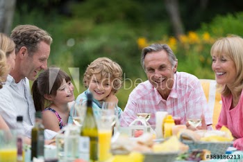 Happy multi-generation family enjoying lunch on patio