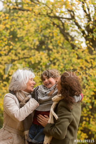 Happy multi-generation family in autumn park