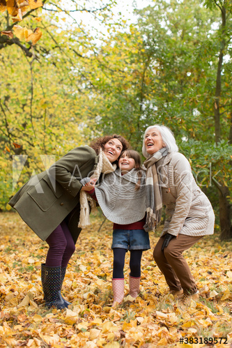 Happy multi-generation family in autumn woods