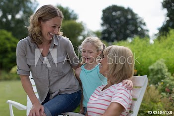 Happy multi-generation women bonding in garden
