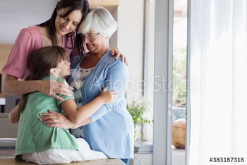 Happy multi-generation women hugging