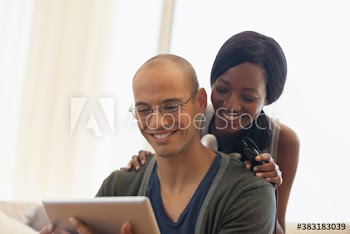 Happy multiethnic couple using digital tablet