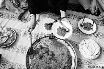 Happy Muslim family eating at home