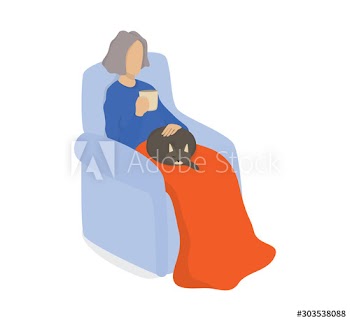 Happy old woman sitting in the armchair with a cat on her laps