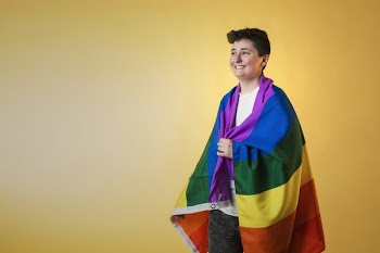 Happy Person Wrapped Rainbow Flag