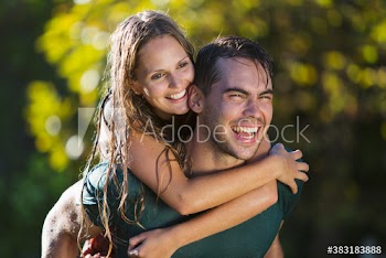 Happy playful young couple piggybacking