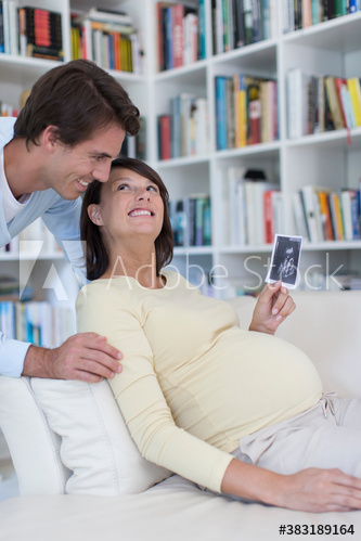 Happy pregnant couple looking at ultrasound