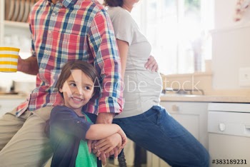 Happy pregnant family in kitchen