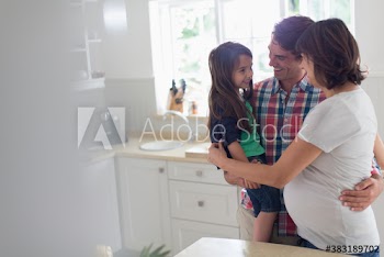 Happy pregnant family in kitchen