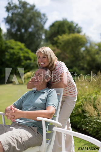 Happy senior couple in sunny garden