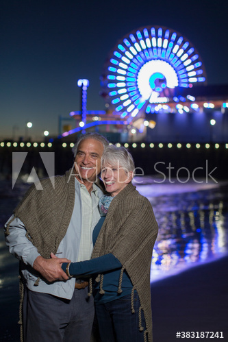 Happy senior couple on beach at night, Santa Monica, California, USA