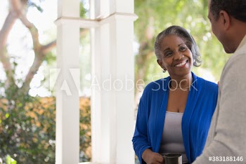 Happy senior couple talking on porch