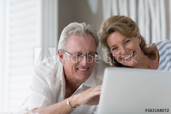 Happy senior couple using laptop