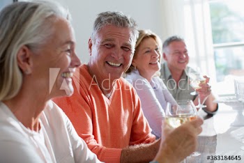Happy senior couples drinking white wine