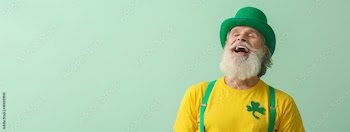 Happy senior man in green hat on light background with space for text. St. Patrick's Day celebration
