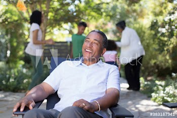 Happy senior man on patio with family