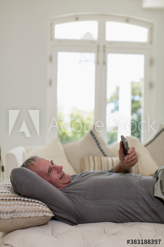 Happy senior man relaxing with smart phone
