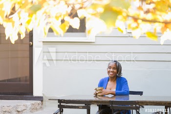 Happy senior woman drinking coffee on patio
