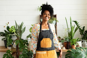 Happy small business owner at a plant shop | Free stock photo | High Resolution image