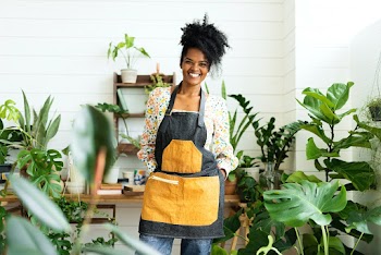 Happy small business owner at a plant shop | Free stock photo | High Resolution image