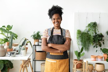 Happy small business owner at a plant shop | Free stock photo | High Resolution image