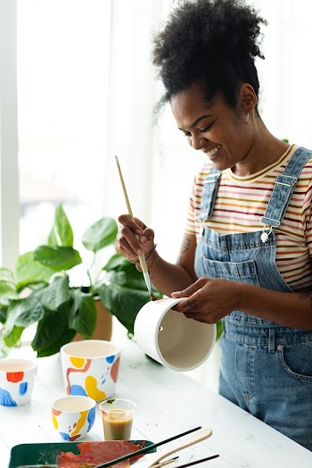 Happy woman at home DIY pot painting hobby | Free stock photo | High Resolution image