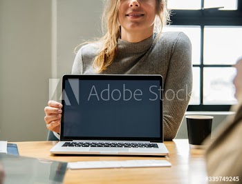 Happy woman with a blank laptop screen