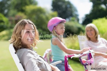Happy woman with family in sunny garden