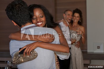 Happy young couple hugging at party