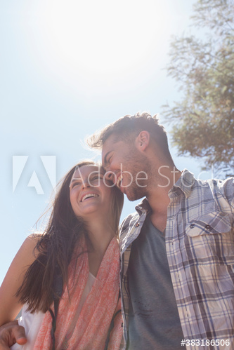 Happy young couple hugging in sunshine