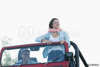 Happy young couple in jeep
