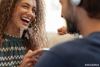 Happy young couple using smart phone