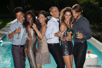 Happy young friends dancing and drinking at poolside party