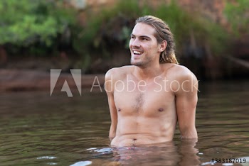 Happy young man relaxing in lake