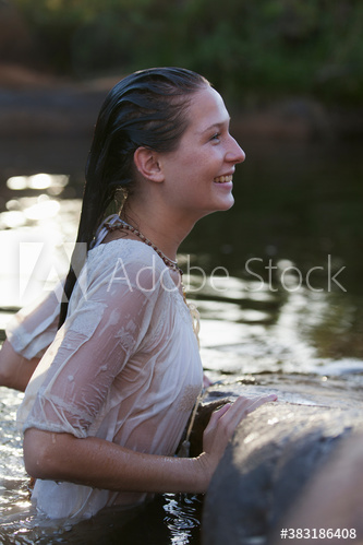 Happy young woman in lake