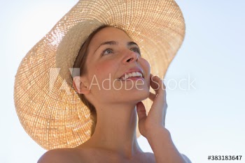 Happy young woman in sun hat